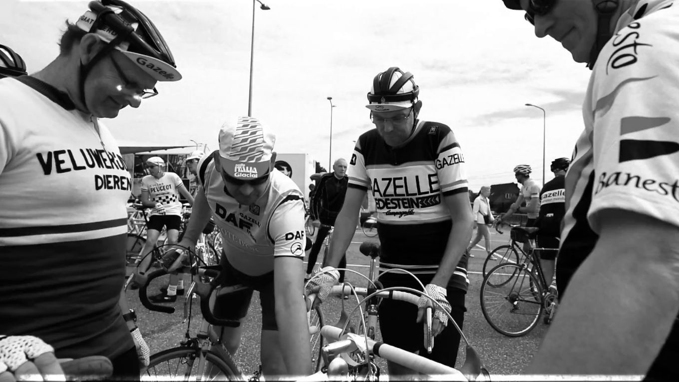 Mannen staan met fietsen aan de hand